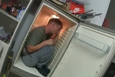 Domestic abuser who hid in fridge jailed for three years