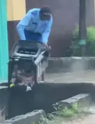 Netizens blame LAWMA after school guard dumps trash in drainage